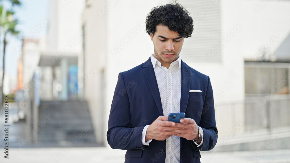 Sticker Young latin man business worker using smartphone at street