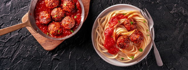 Meatballs panorama. Beef meat balls, shot from above in a pan and with a plate of spaghetti pasta,...