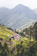 Obraz premium stone house in the mountains with woods background