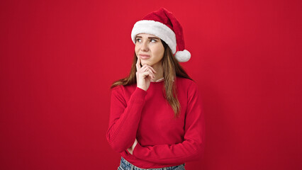Young hispanic woman wearing christmas thinking over isolated red background
