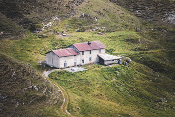 stone hut in the meadow in the mountains