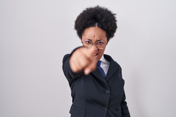 Obraz premium Beautiful african woman with curly hair wearing business jacket and glasses pointing displeased and frustrated to the camera, angry and furious with you