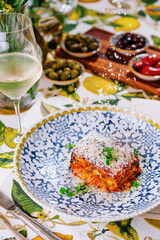 lasagna with and glass of white wine