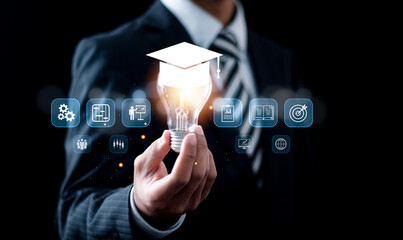 online education concept, Businessman holding light bulb with E-learning education icons for internet lessons and online webinar. study knowledge, creative thinking idea, education internet technology