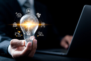 AI technology concept. Businessman holding light bulb with AI tools for big data network...