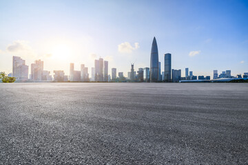 Asphalt road and urban skyline with modern buildings at sunset in Shenzhen, China. - obrazy, fototapety, plakaty