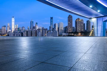 Foto op Canvas Empty square floor and pedestrian bridge with modern buildings at night in Chongqing, China. © ABCDstock