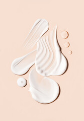 cosmetic smears of creamy texture on a beige background