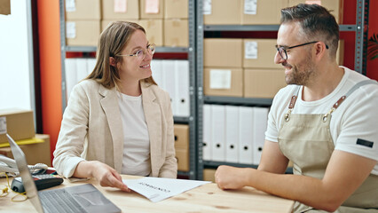 Fototapeta premium Young woman and man working on ecommerce on a meeting at office