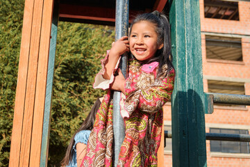 brown-skinned latina girl playing in an outdoor park - fun concept