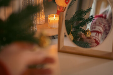 Beautiful and decorated Christmas tree in the mirror reflection. Christmas mood. Great photo for greeting card. Boho Scandinavian Style Design. Close up of Christmas tree adorning. New Year decoration
