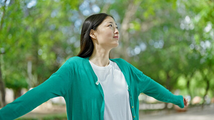 Young chinese woman smiling confident breathing at park