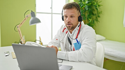 Young man doctor on video call at clinic