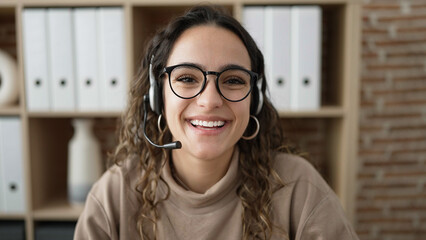 Young beautiful hispanic woman call center agent smiling confident working at office