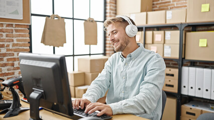 Young caucasian man ecommerce business worker listening to music dancing at office