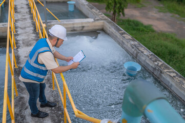 Environmental engineers work at wastewater treatment plants,Water supply engineering working at Water recycling plant for reuse - obrazy, fototapety, plakaty