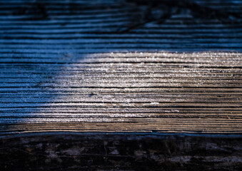 Wooden boards covered with frost.