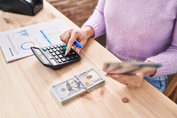 Young caucasian woman ecommerce business worker holding dollars accounting at office