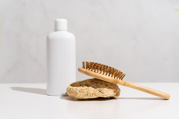 White plastic bottle mock up, used for shampoo and conditioner and hair wood comb on white background