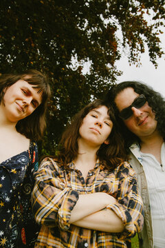 Portrait of diverse group of friends wearing street style clothes at the park looking into camera