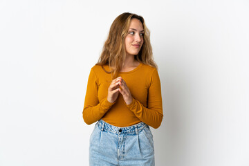 Young blonde woman isolated on blue background scheming something