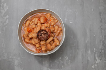 typical portuguese dish dobrada with beans in white dish