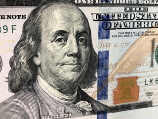 Closeup view of Benjamin Franklin's face on a 100$ bill