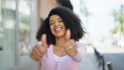 African american woman smiling confident doing ok sign with thumbs up at street