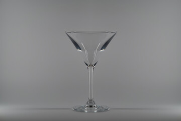 Empty glass of martini on gray background.

