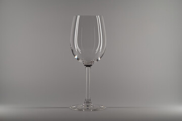 Empty clean wine glass isolated on white gray background.