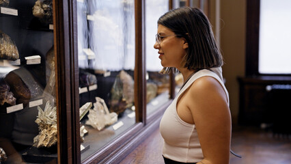 Young beautiful hispanic woman visiting geological exhibition at Natural History Museum in Vienna