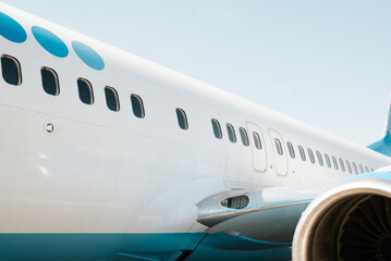 Close-up of an airplane on the runway, row of windows outdoors - obrazy, fototapety, plakaty