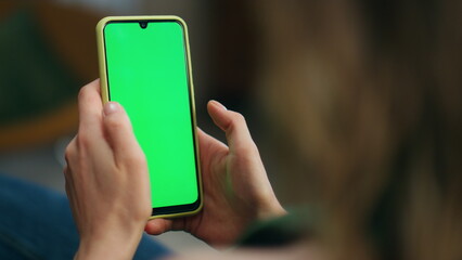 Woman hand swiping green phone screen closeup. Unknown relaxed girl scrolling - obrazy, fototapety, plakaty