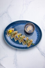 Gyoza dumplings on a blue plate