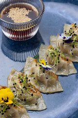 Gyoza dumplings on a blue plate