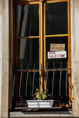 Free Palestine writings at the apartment windows of Brussels, call for peace, ceasefire and end of...