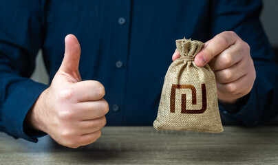 The man approves the deal or loan. Thumbs up and israeli shekel money bag. Agreement to be hired...