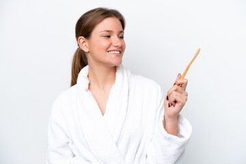 Young caucasian woman brushing teeth isolated on white background with happy expression