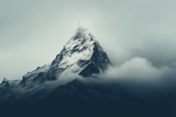 Stunning minimalist background of single mountain in fog and clouds