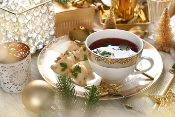 Elegantly served  Christmas Eve red borsht with dumplings