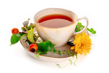 Tea with various ingredients. Teacup and herbs, fruits, and flowers, shot on a white background. Healthy natural remedies