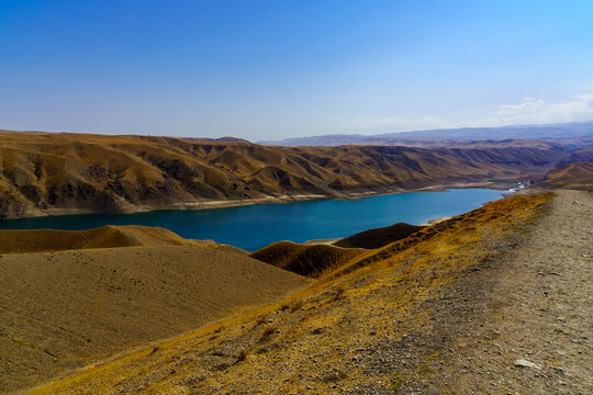 A deserted part of the Zaamin nature reserve in Uzbukistan on a sunny summer day. View of the mountains and reservoir.
