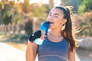 Young pretty sport woman doing sport with a bottle of water