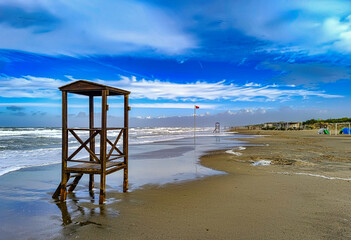 In the foreground lifeguard station used in summer on the beach of Marina di Castagneto Carducci...