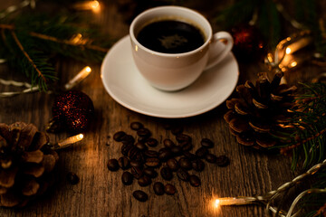 Coffee break on Christmas evening. A cup of espresso coffee on the table