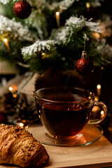 Croissant and tea. Pastries for Christmas. Fast food during the winter holidays