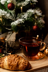 Croissant and tea. Pastries for Christmas. Fast food during the winter holidays