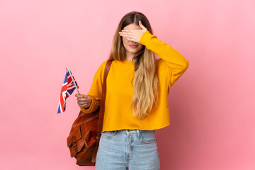Young blonde woman holding an United Kingdom flag isolated on white background covering eyes by hands. Do not want to see something - obrazy, fototapety, plakaty