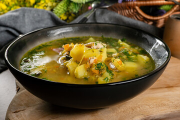 Cucumber soup in dark bowl.
