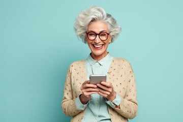 Middle aged single woman smiling texting on social media app smartphone
